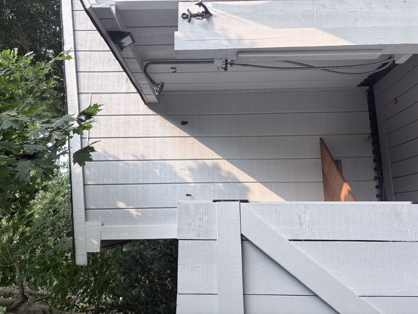 Private outdoor shower on the side of the shed